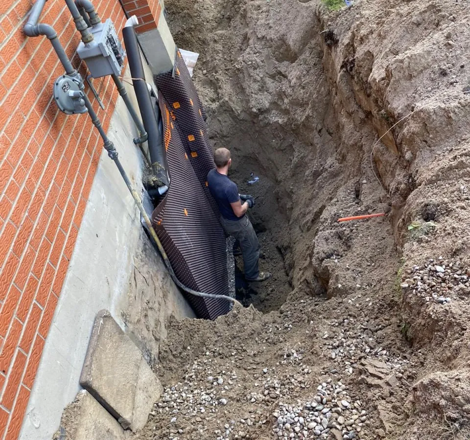 Foundation wall cleaning and preparation for waterproofing