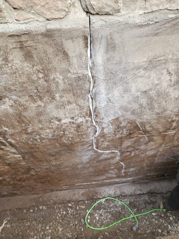 Vertical foundation crack visible on basement wall